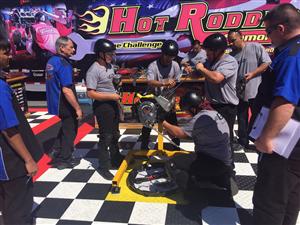 5 boys working on assembling the engine at the Hot Rodders competition 